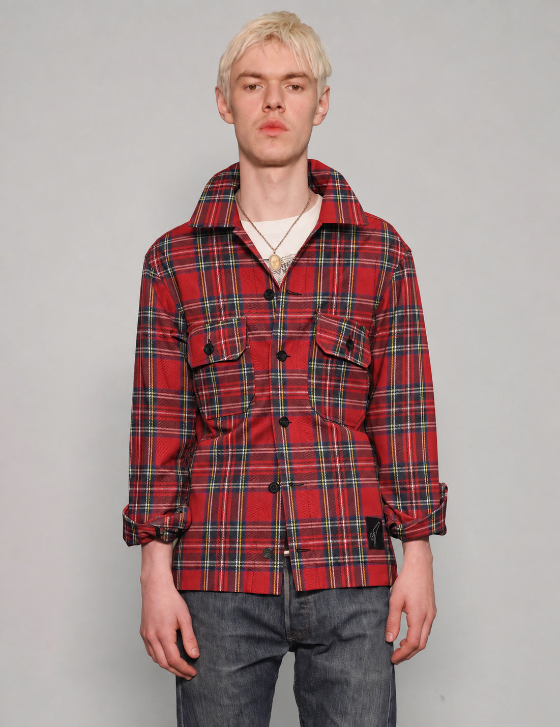 STUART TREVOR red tartan cotton workshirt buttoned up, showing black buttons and two chest pockets.