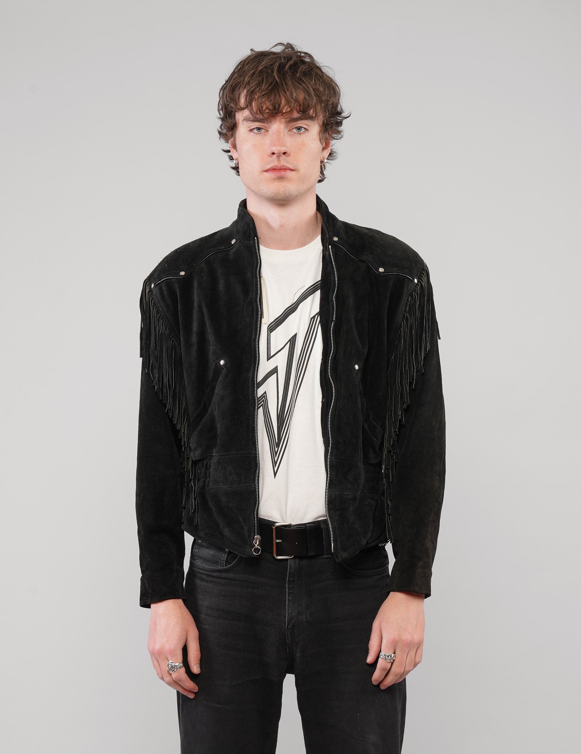 Front view of the studded fringed zip jacket in black.