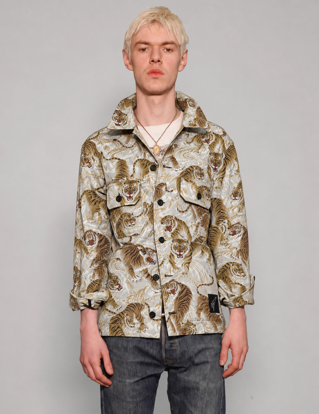 STUART TREVOR ivory and gold tiger workshirt buttoned up, showing two chest pockets.