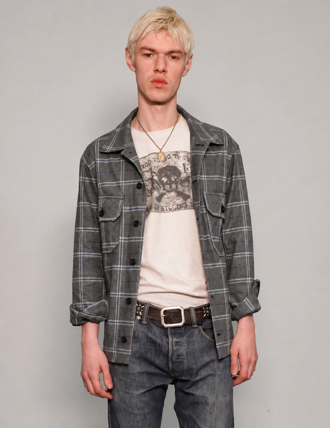 STUART TREVOR charcoal windowpane workshirt worn open over a graphic T-shirt.