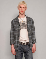 STUART TREVOR charcoal windowpane workshirt worn open over a graphic T-shirt.