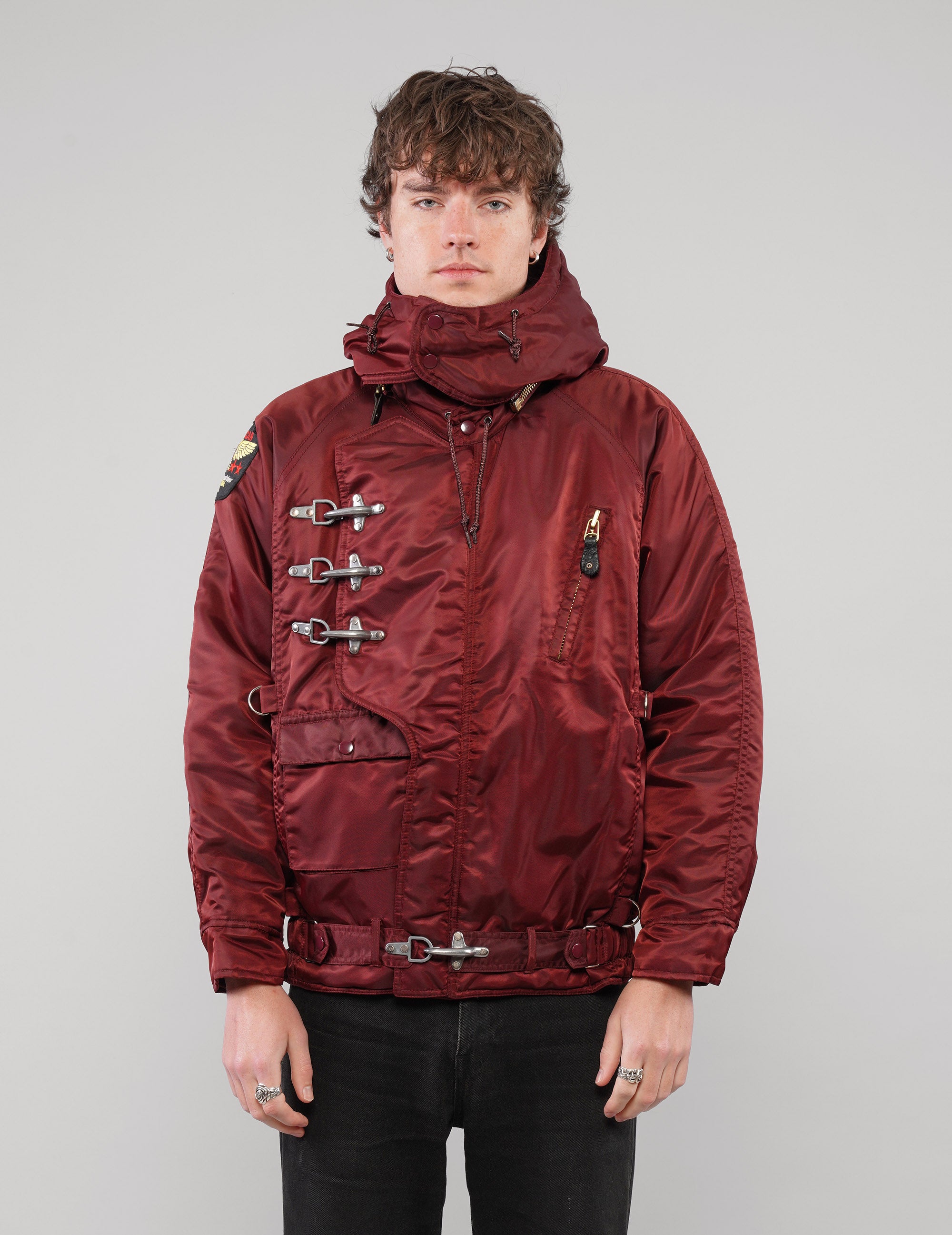 Front view of a burgundy hooded clasp-front jacket.