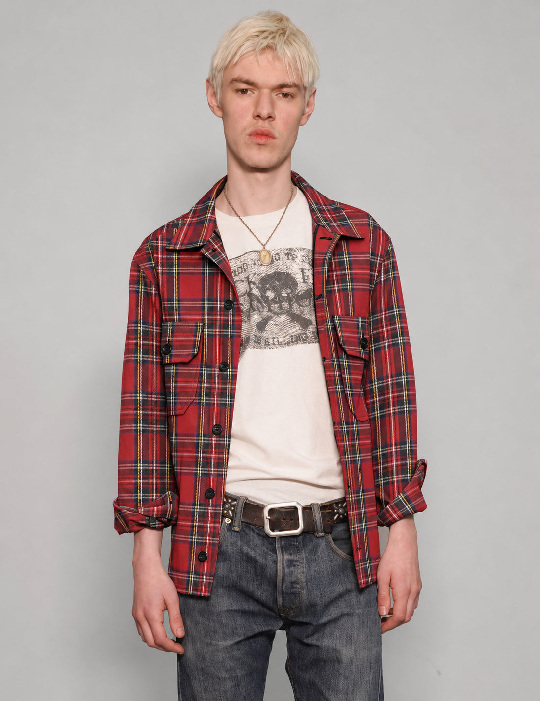 STUART TREVOR red tartan cotton workshirt worn open over a graphic T-shirt.