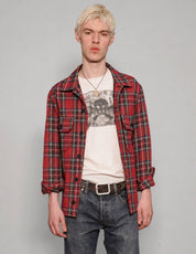 STUART TREVOR red tartan cotton workshirt worn open over a graphic T-shirt.