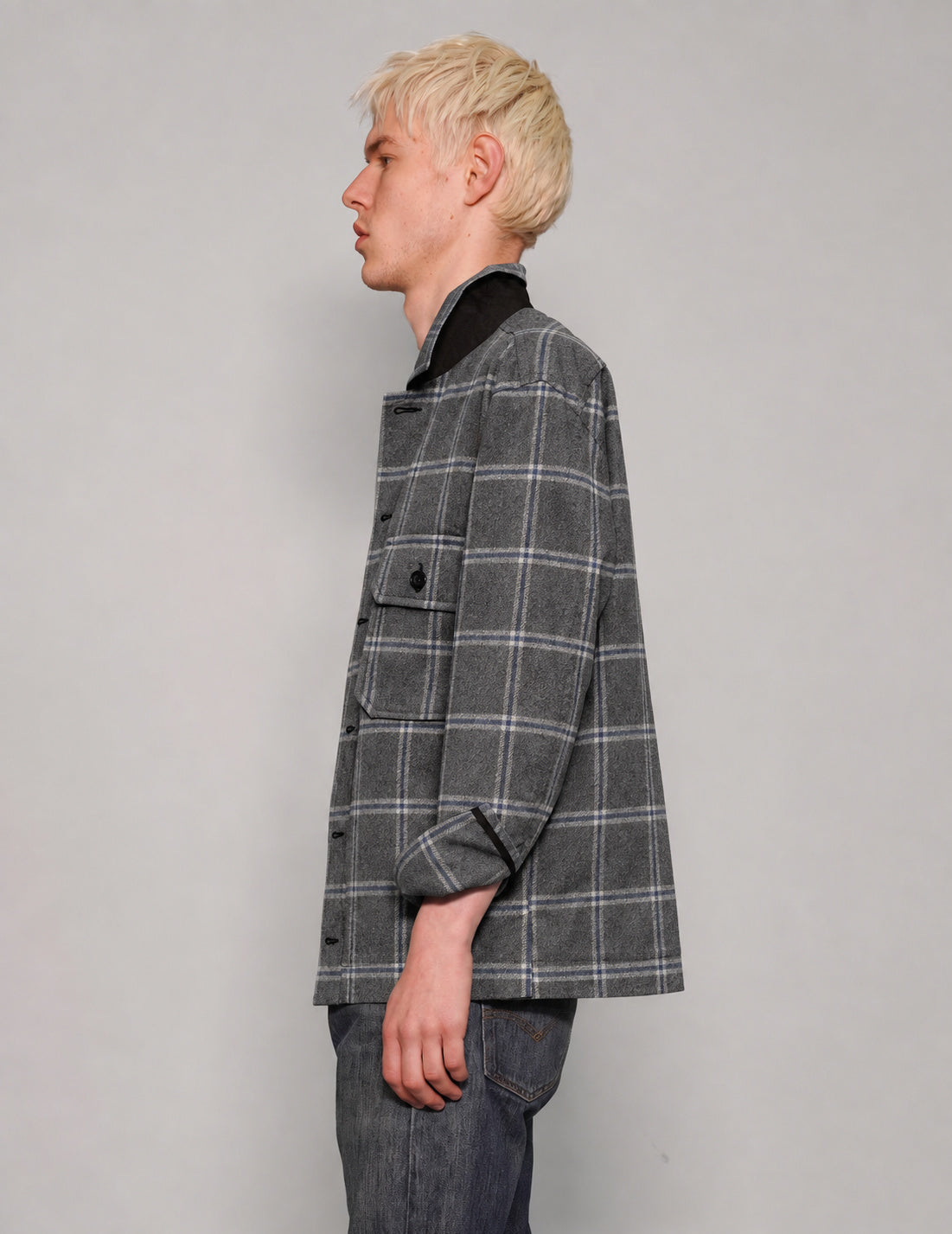 Side view of STUART TREVOR charcoal windowpane workshirt with turned-up collar.