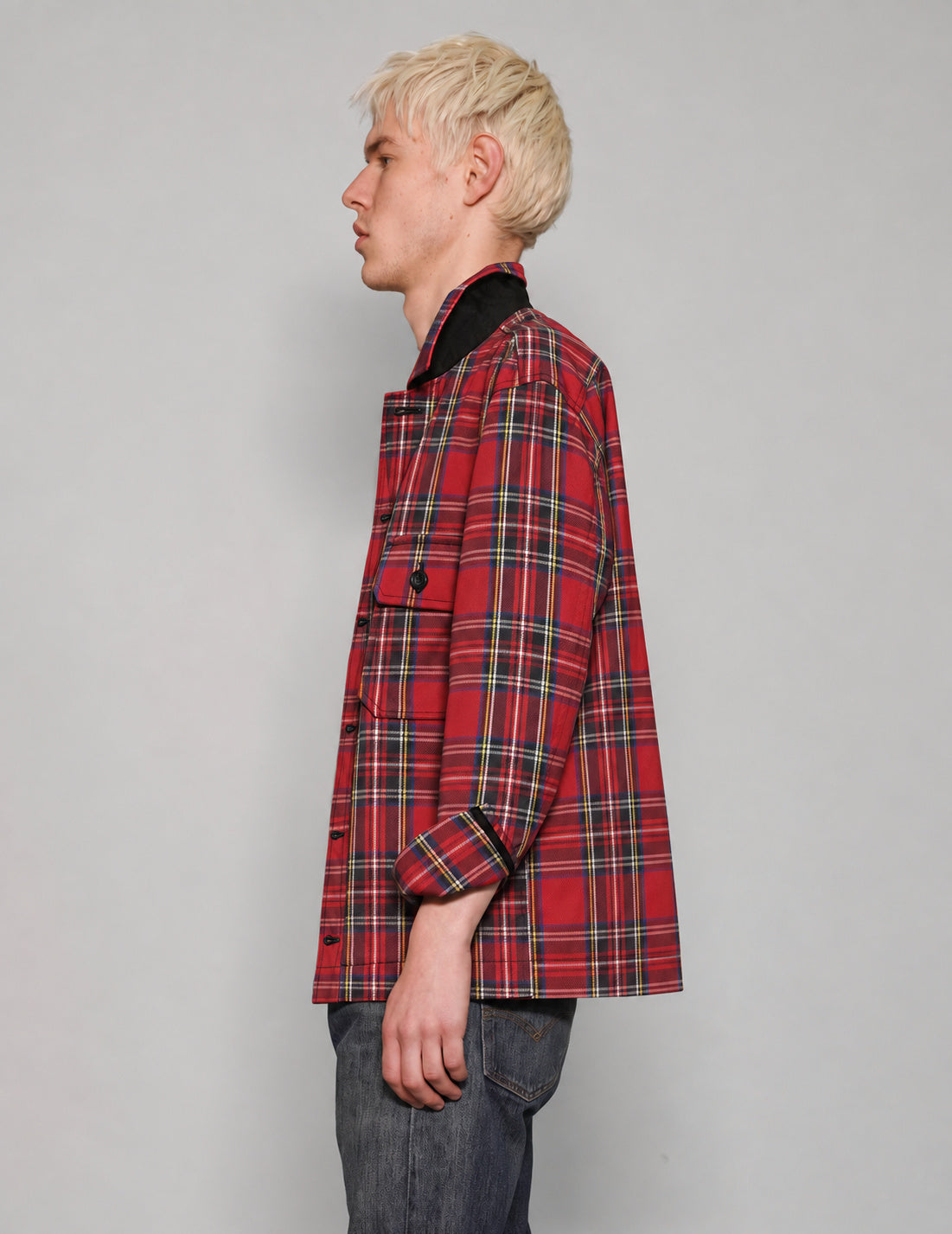 Side view of STUART TREVOR red tartan cotton workshirt with turned-up collar.
