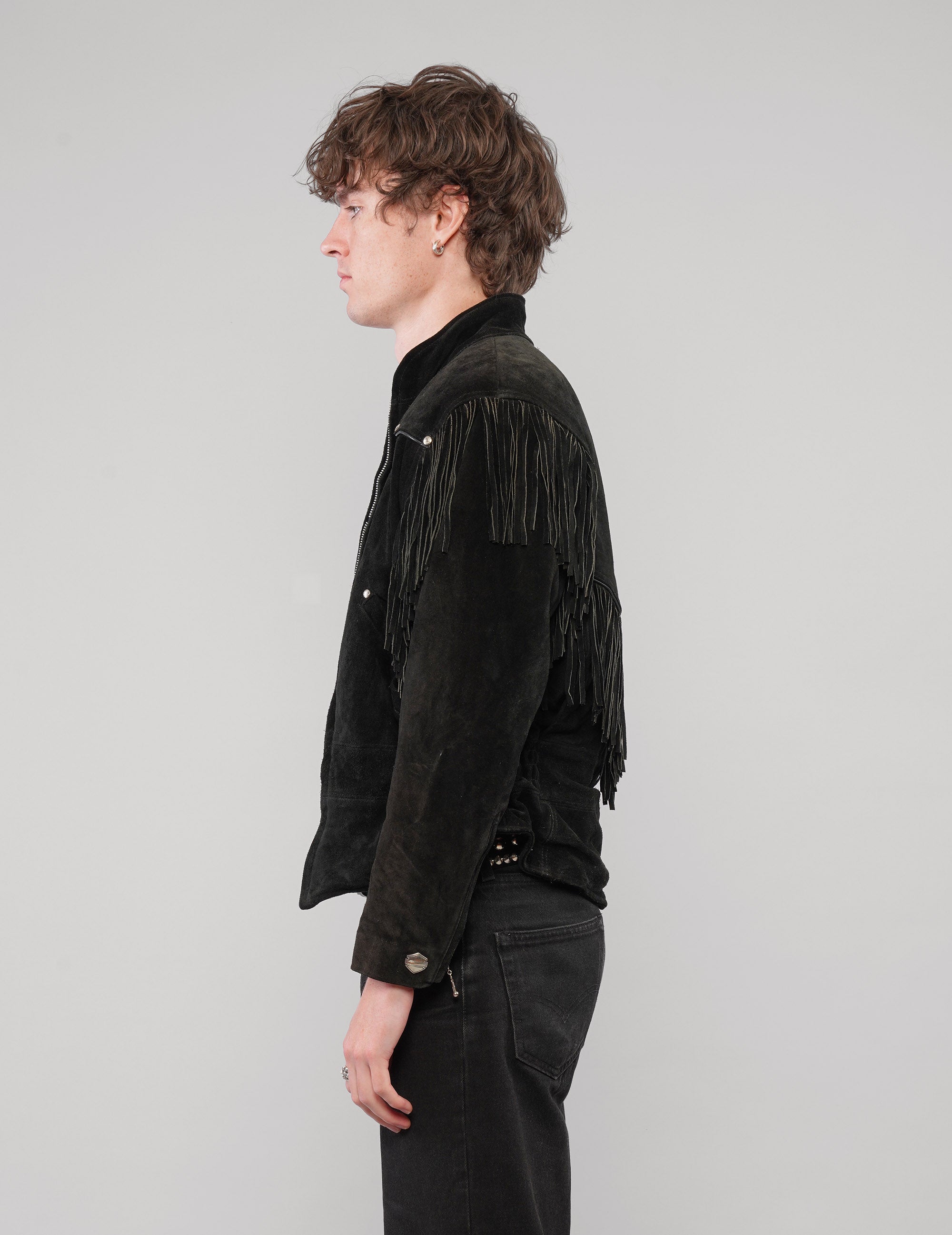Left side view of the studded fringed zip jacket in black.