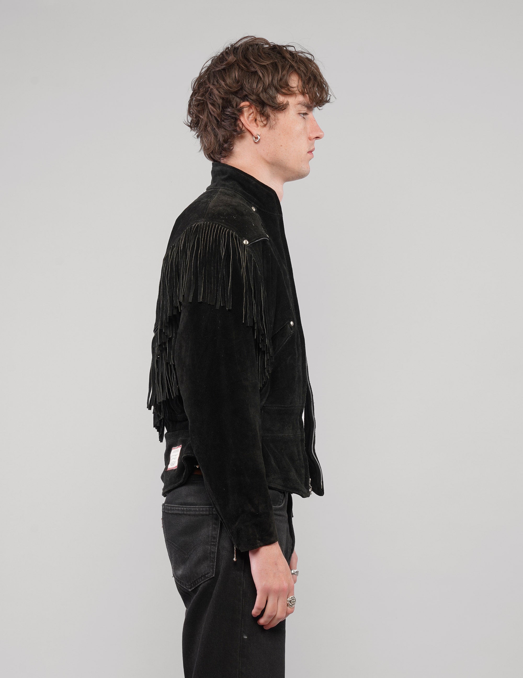 Right side view of the studded fringed zip jacket in black.