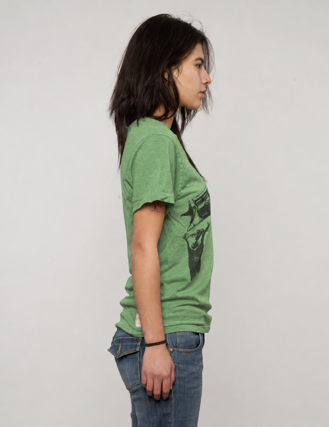 Green Crossed Pistols tee flat lay showing crossed pistols graphic