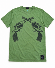 Woman wearing a green Crossed Pistols tee, profile view