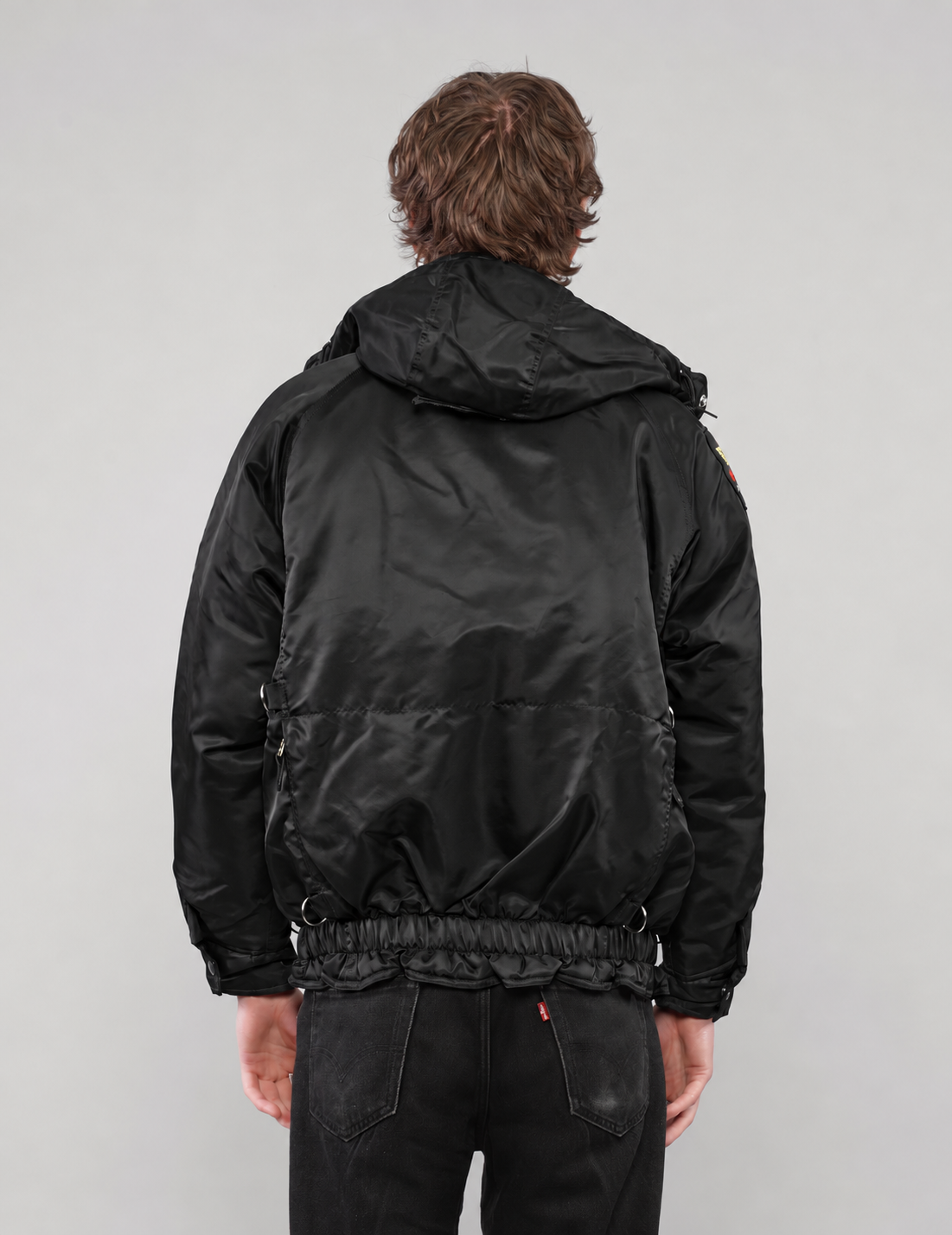 Black hooded clasp-front jacket, sleeve patch and side view