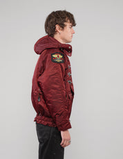 Right side view of a burgundy hooded clasp-front jacket.