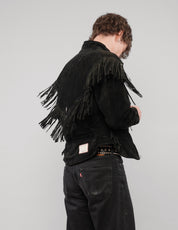 Back three-quarter view of the black fringed zip jacket.