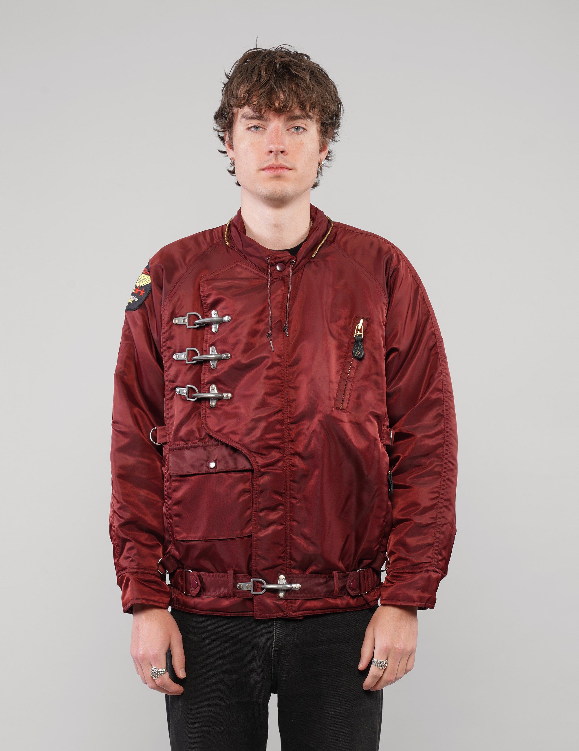 Front view of a burgundy clasp-front jacket without the hood.