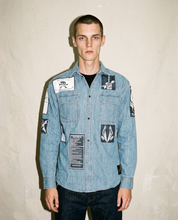 Light blue patched denim shirt worn front-on