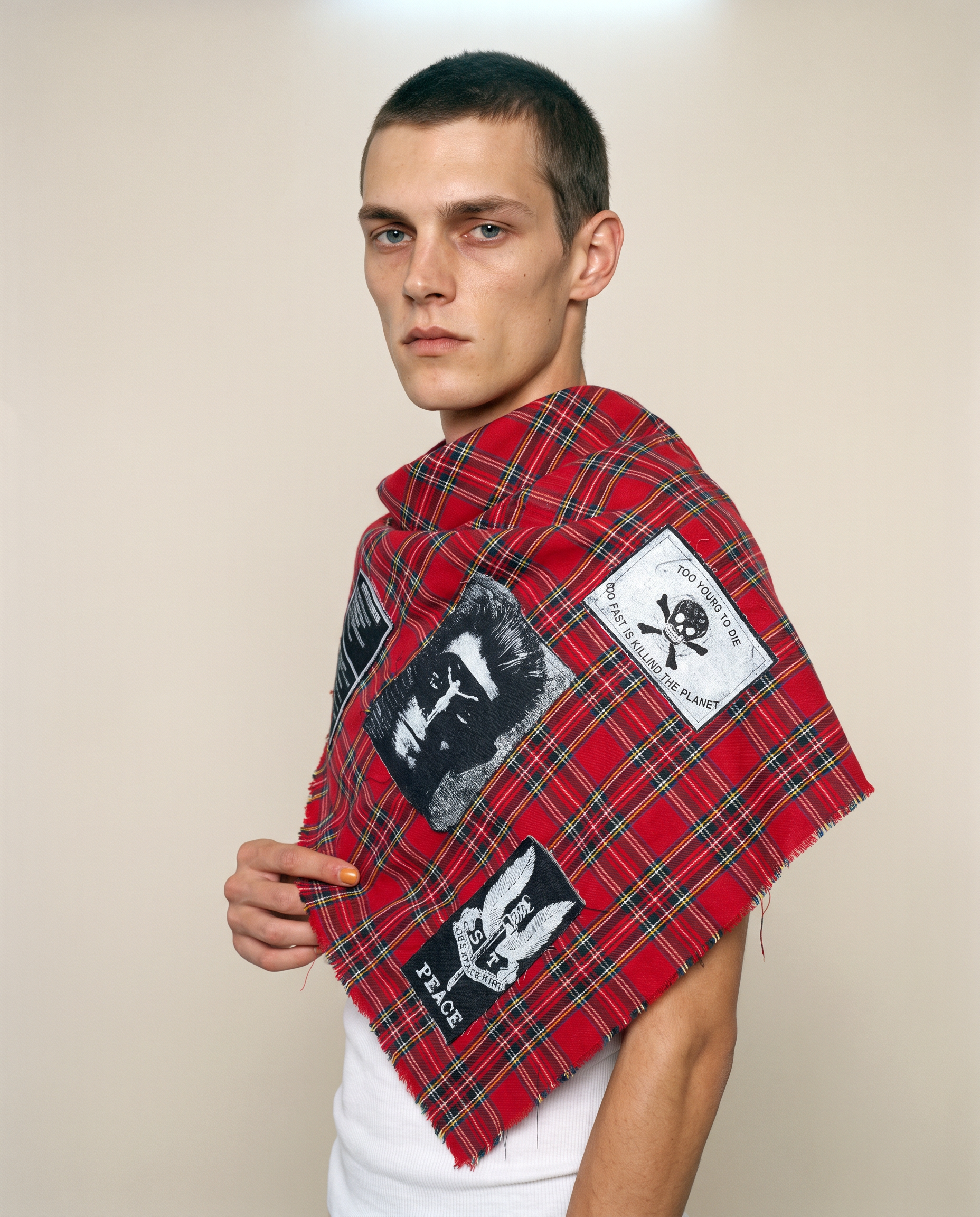 Generated_with_Kive.ai_-_Minimal_Fashion_Studio_The_Riot_Patched_Scarf_in_Red_Tartan_Mads_give_me_a_side_shot.png