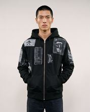 Black zip hoodie worn zipped up, front view with the hood down
