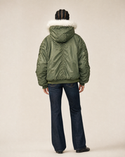 Back view of the green flying jacket with the hood up