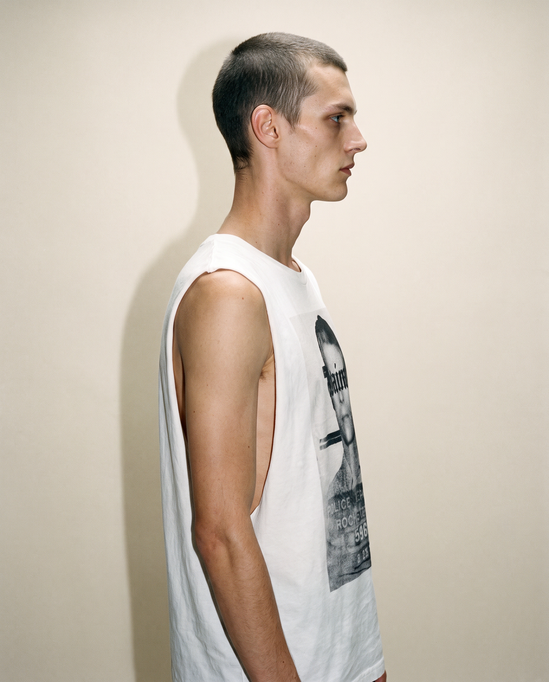 Side view of the ecru Saint vest showing the armhole and body shape