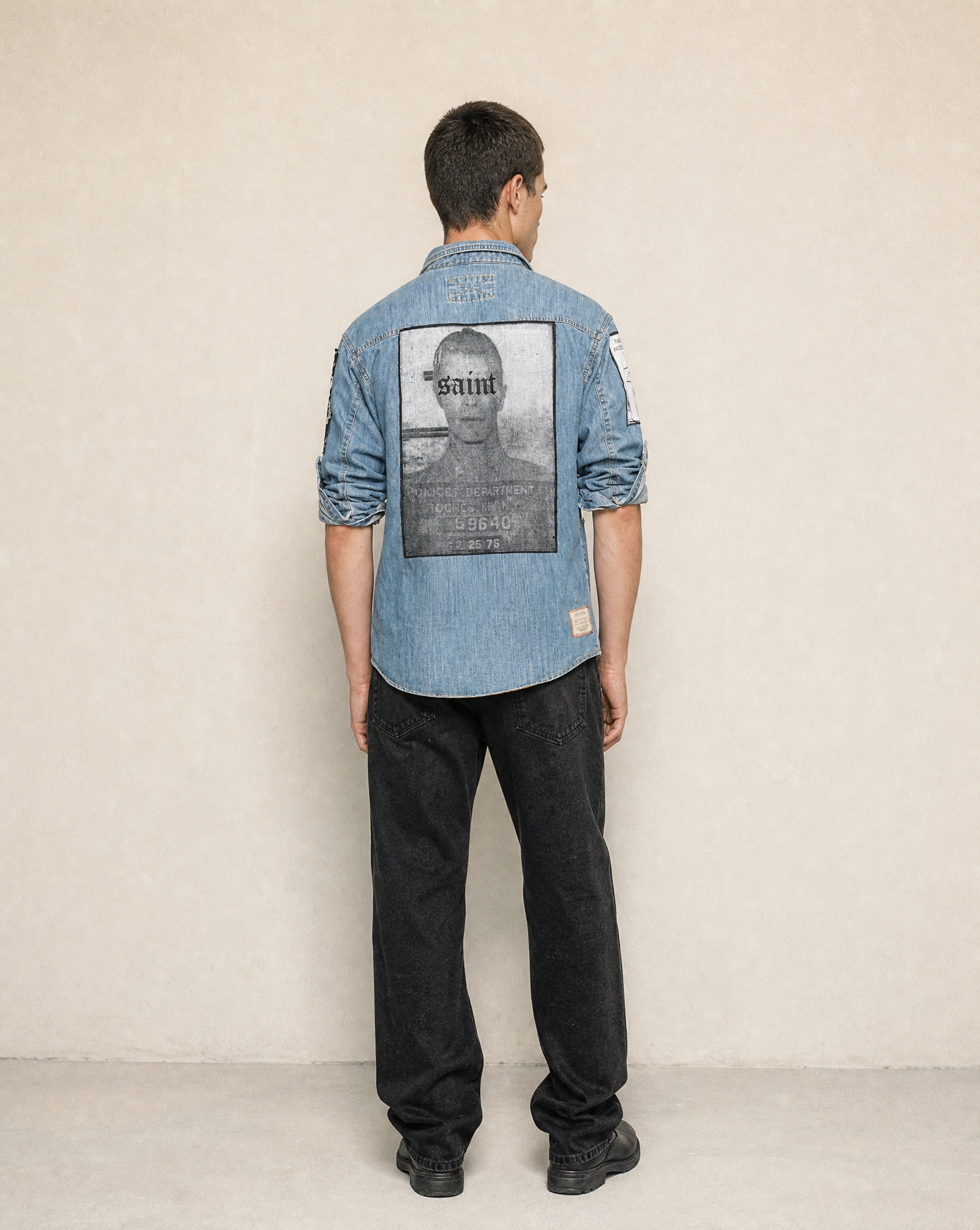 Back view of the light blue denim shirt showing the patch detail