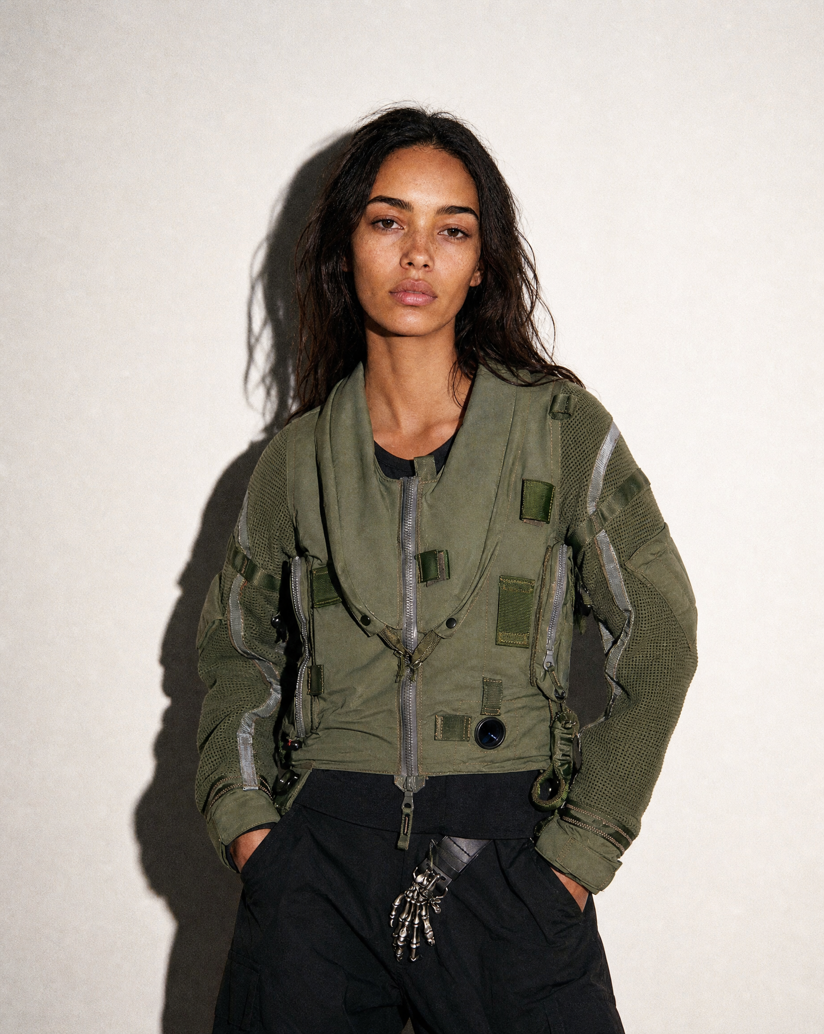Woman wearing a vintage khaki RAF Hurricane flight jacket, full length