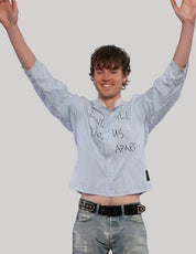 Model with arms raised wearing a light blue pinstripe Love Will cropped shirt, showing its short straight-cut hem.