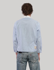 Back view of an upcycled Ralph Lauren light blue pinstripe cropped shirt with long sleeves and a straight hem.