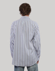 Back view of a blue multi-stripe cotton shirt showing vertical stripes of varying widths and long cuffed sleeves.