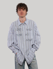 Model wearing a loose-fitting blue Love Will multi-stripe shirt with hands in pockets, styled with light blue jeans.