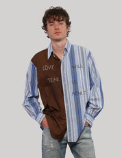 Model wearing a brown and blue 'Love Will' split shirt with contrasting striped panels and handwritten graphic lettering.