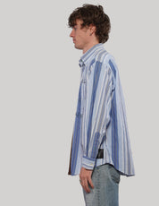 Side view of the 'Love Will' split shirt showing its blue and white striped panel, pointed collar and long sleeves.