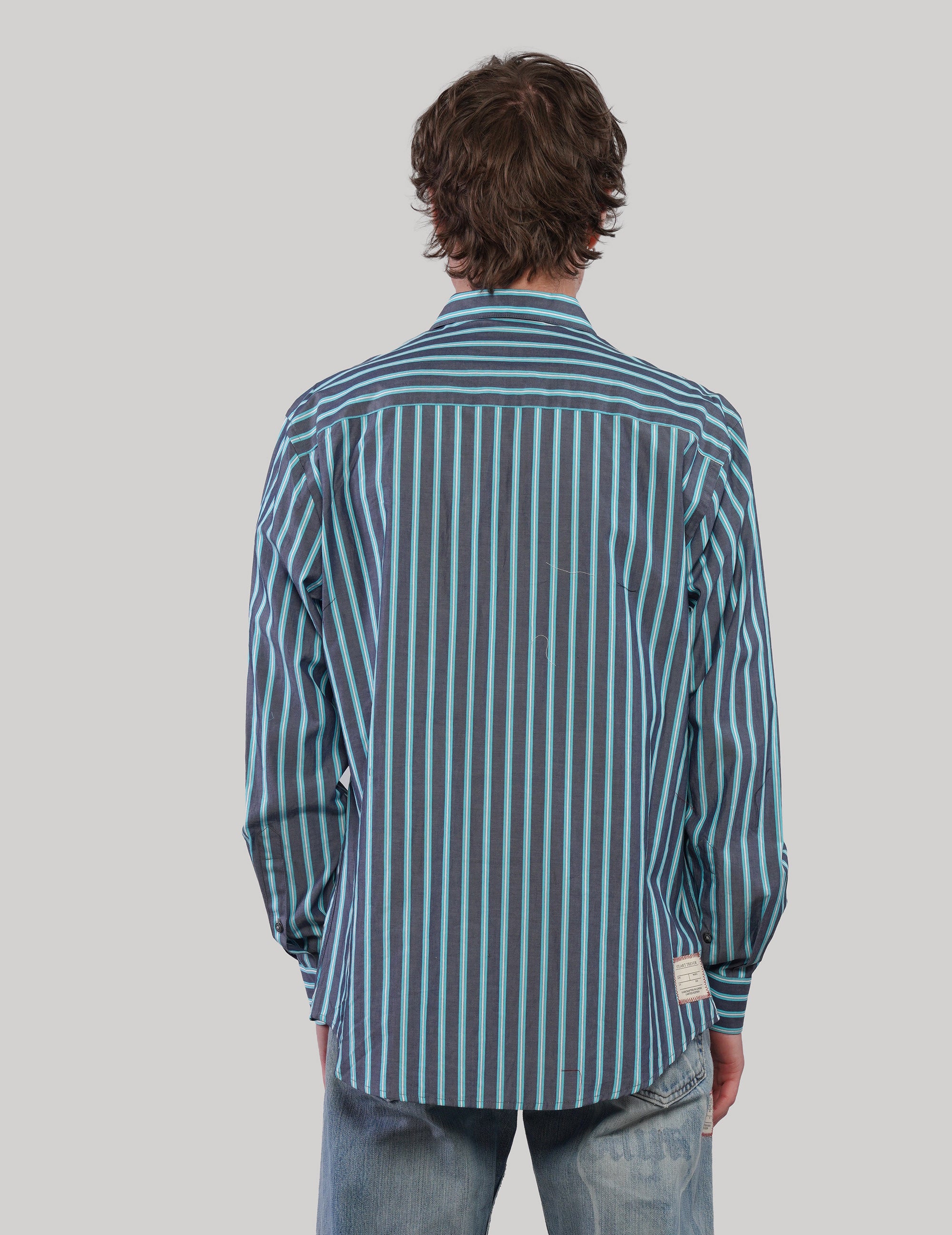 Back view of a teal and light blue striped cotton shirt with long sleeves, pointed collar and curved hem.