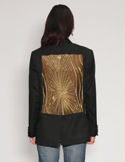 Back view of black tuxedo jacket showing full gold sequin starburst panel