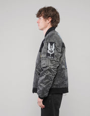 Left-side view of a model in the charcoal bomber jacket, showing the Peace sleeve patch and black ribbed trims.