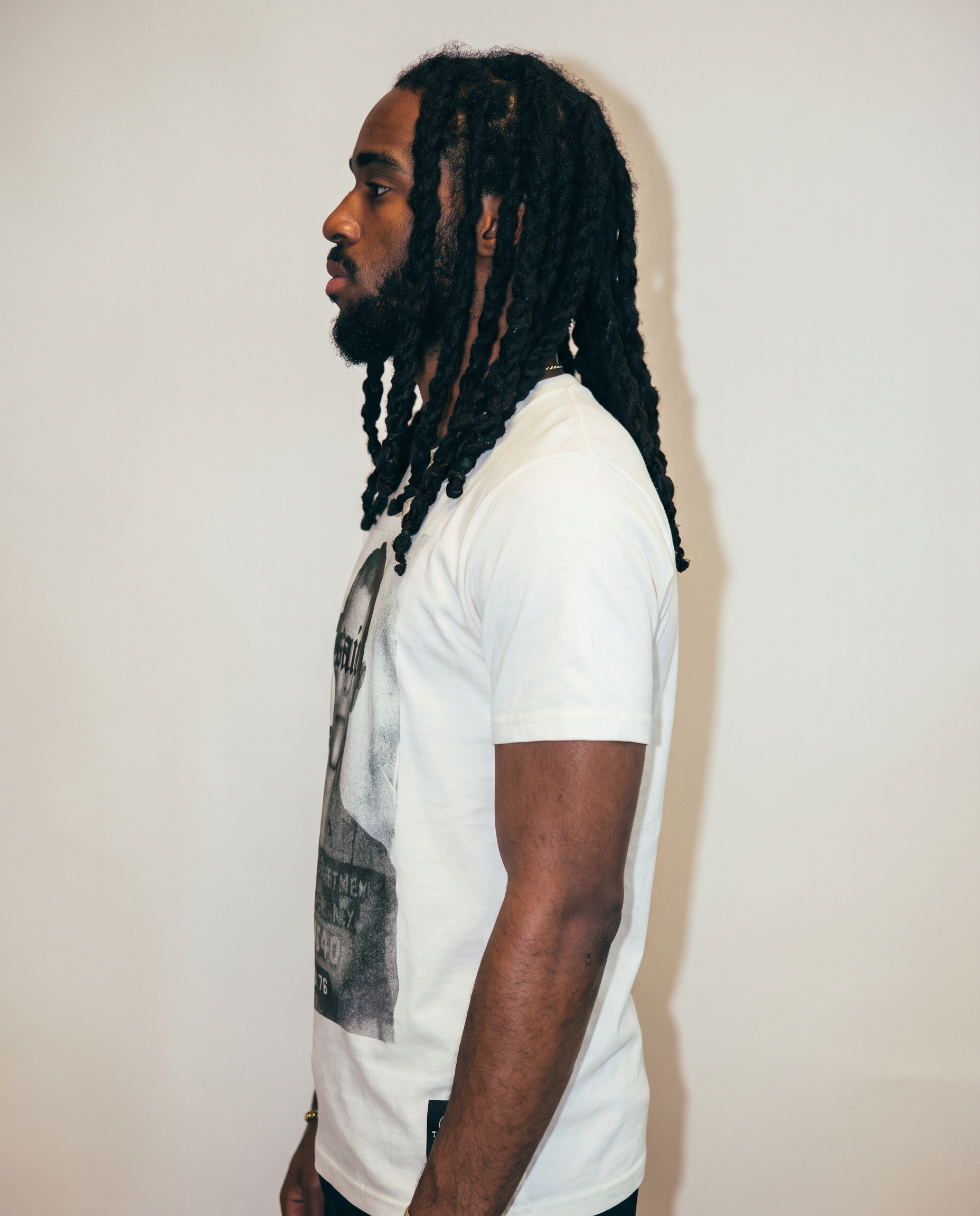 Ecru Saint t-shirt from the side, showing the medium fit