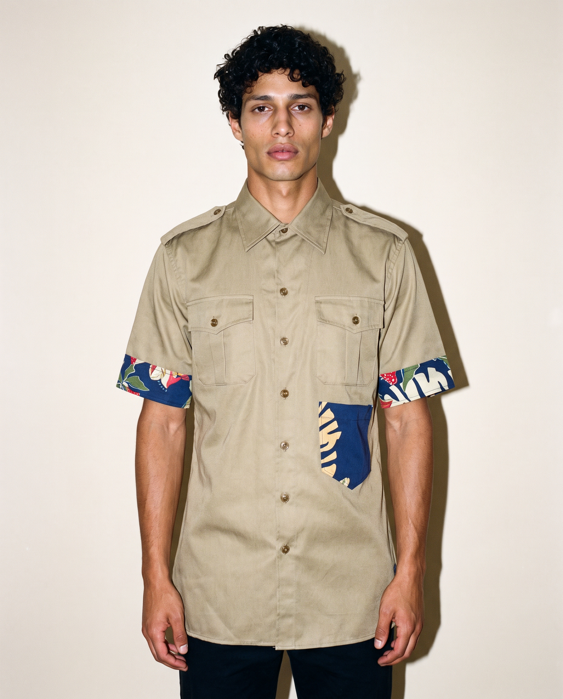 Reworked olive military shirt showing tropical print cuffs and hip patch pocket
