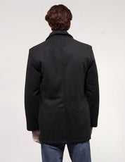 Rear view of black vintage naval peacoat showing its straight silhouette and mid-length cut.