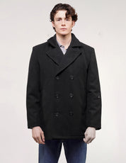 Full front view of black double-breasted naval peacoat with wide lapels, worn with blue jeans.